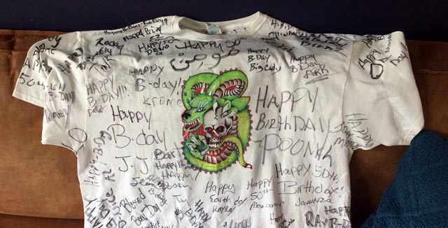 T-shirt with picture of dragon and happy birthday signatures written all over it